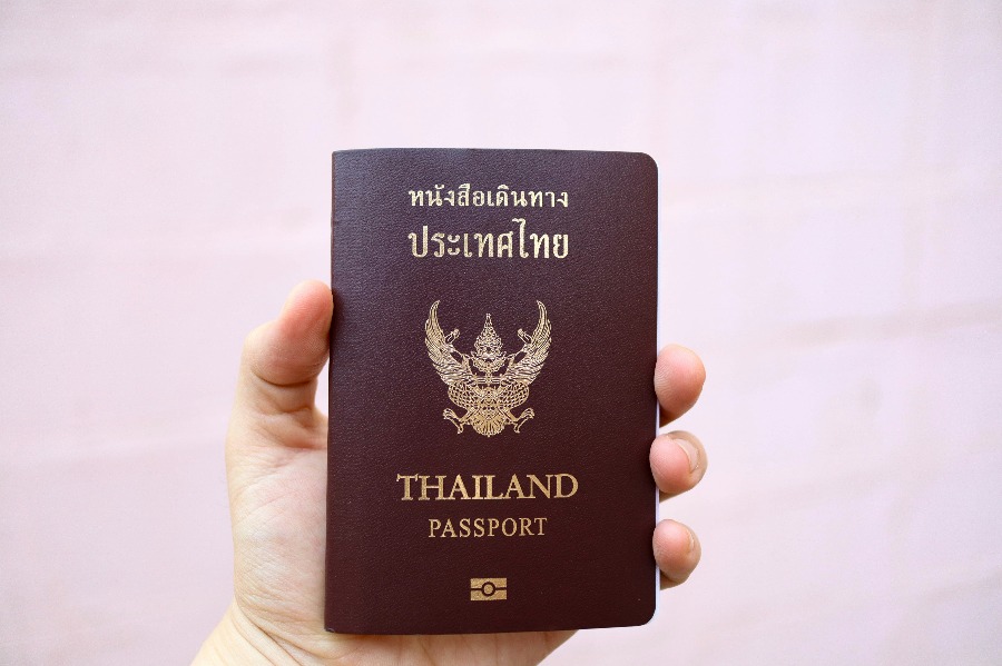 Thai passport and boarding documents on the counter of a business aviation terminal in Bangkok, IBC Aviation